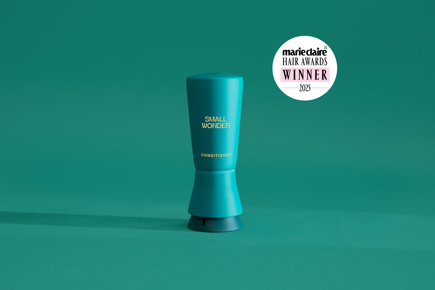 Green Small Wonder Conditioner with Marie Claire Award logo on a green background