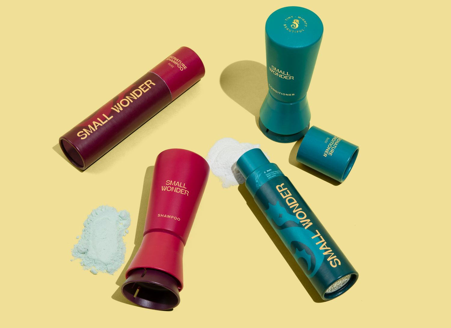 Small Wonder red Shampoo and teal Conditioner bottles and refill tubes with piles of green powder