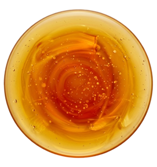 Amber-colored glass bowl with swirling pattern on a white background